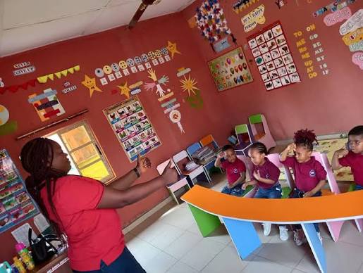 A teacher leading an activity with pupils at Royal Excellentia International School